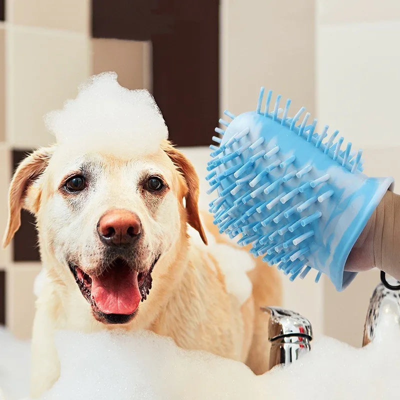Happy Labrador dog being bathed with blue grooming glove covered in soap suds