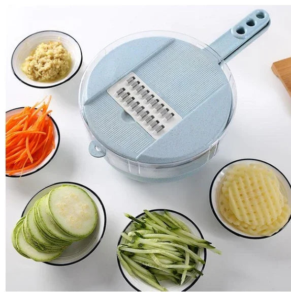 Blue vegetable slicer with handle surrounded by bowls of sliced ginger, shredded carrots, zucchini slices, julienned cucumbers, and crinkle-cut potatoes