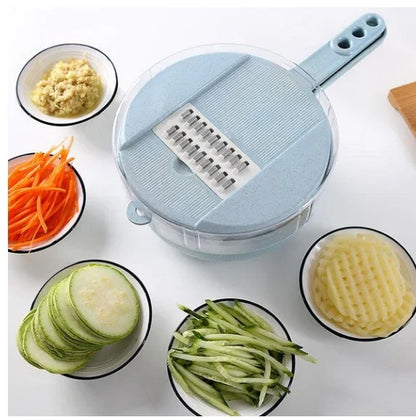 Blue vegetable slicer with handle surrounded by bowls of sliced ginger, shredded carrots, zucchini slices, julienned cucumbers, and crinkle-cut potatoes
