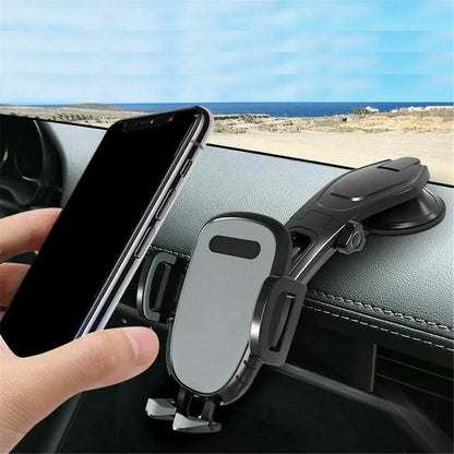 Hand placing smartphone into black dashboard car phone holder mount with suction base