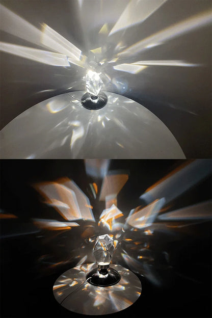 Crystal prism lamp casting colorful light reflections on white and black surfaces in a dark room