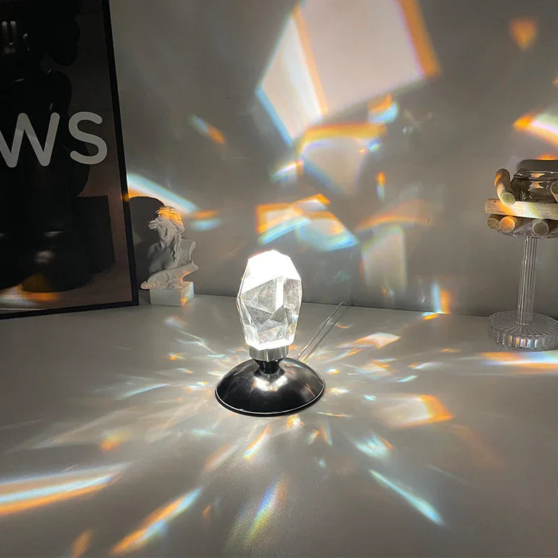 Crystal prism lamp on a table casting colorful light reflections on surrounding surfaces